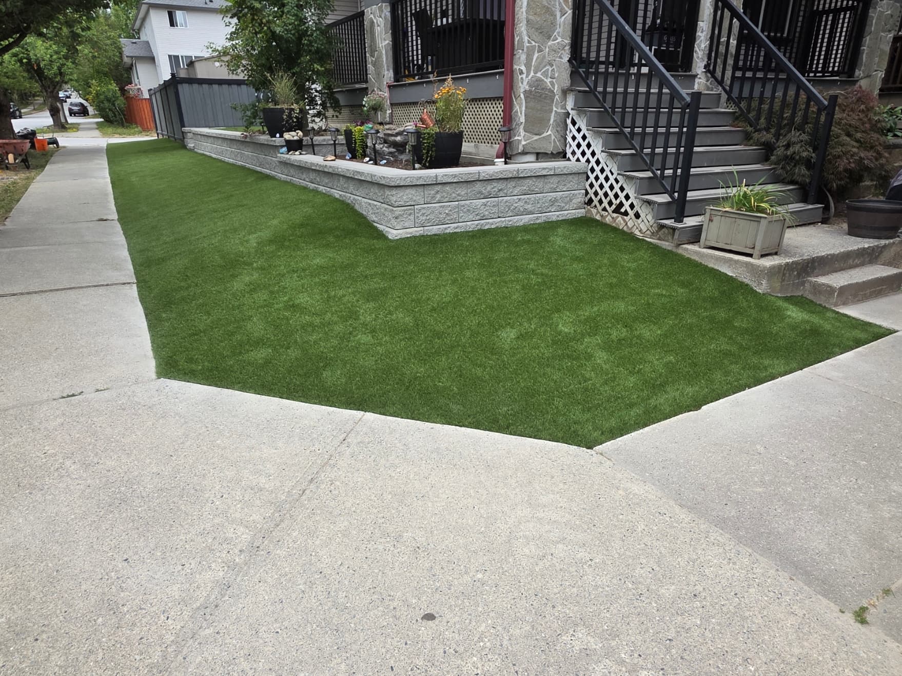 Artificial turf front yard installation paired with an Allan Block retaining wall, Maple Ridge, BC